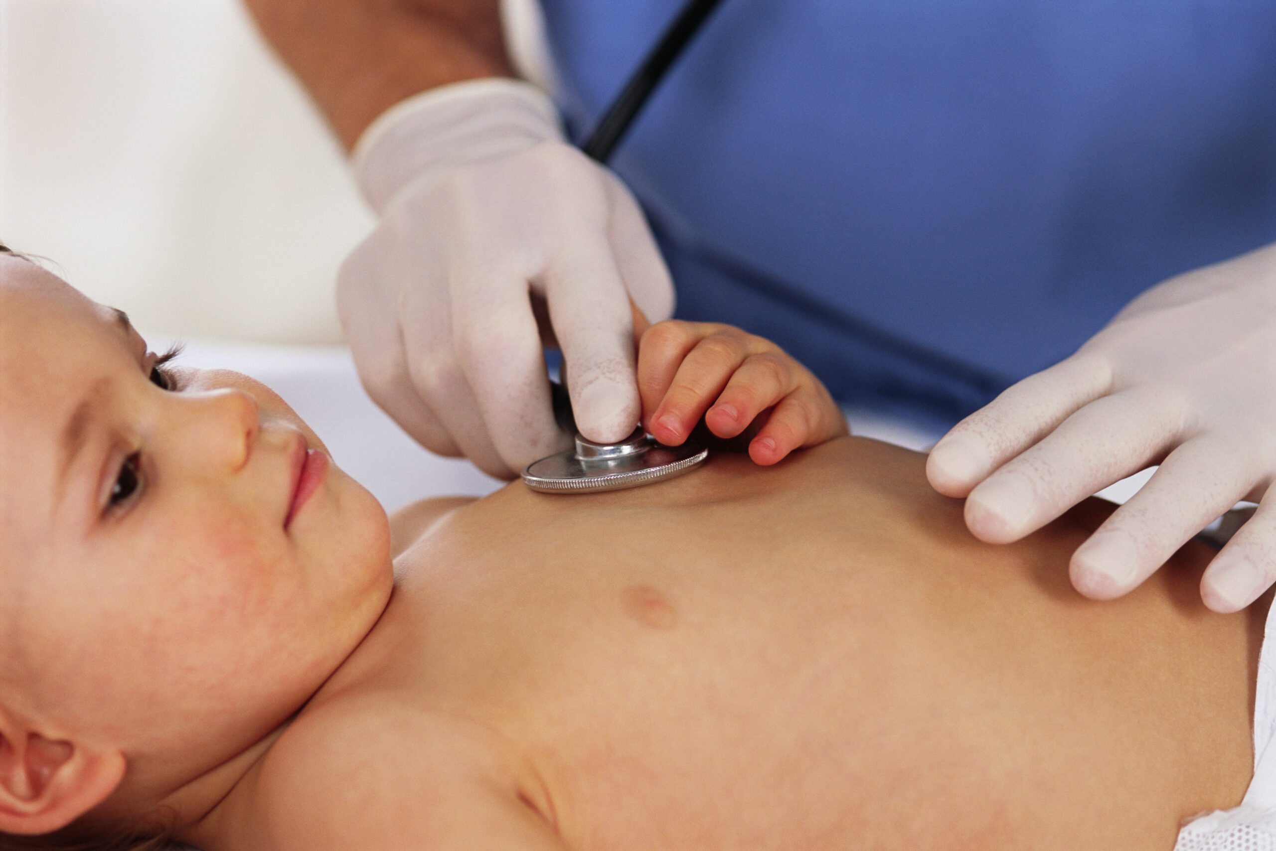 Doctor listing to toddler's heart