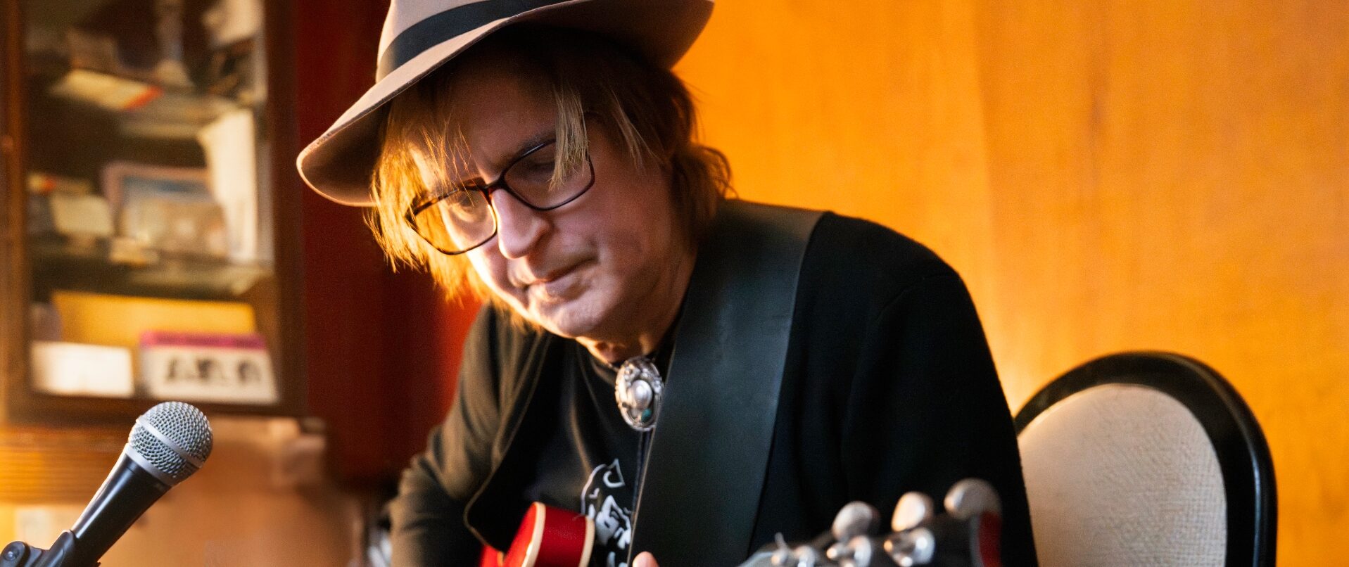 John Berenzy strums guitar