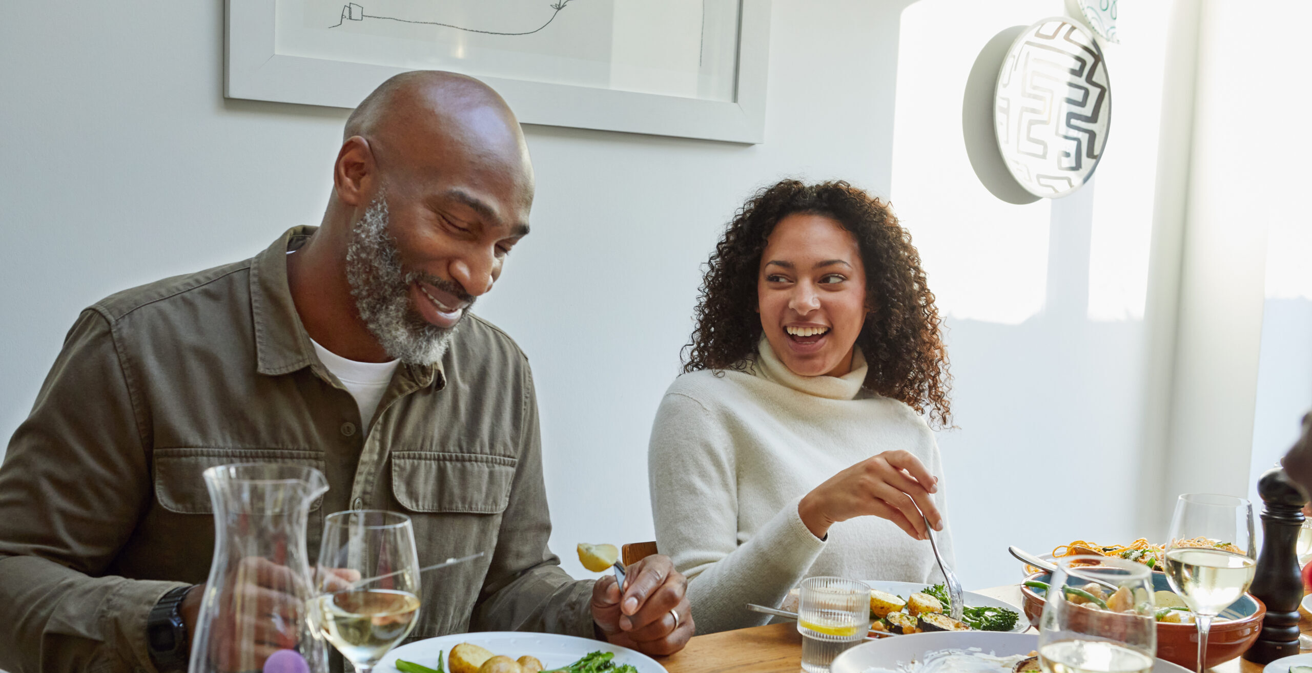 Your Heart in Your 40s, 50s and Beyond: What Changes and What to Watch Group of mixed aged relatives sitting at dining table enjoying home cooked meal talking and laughing, togetherness, healthy eating, meal time, domestic life