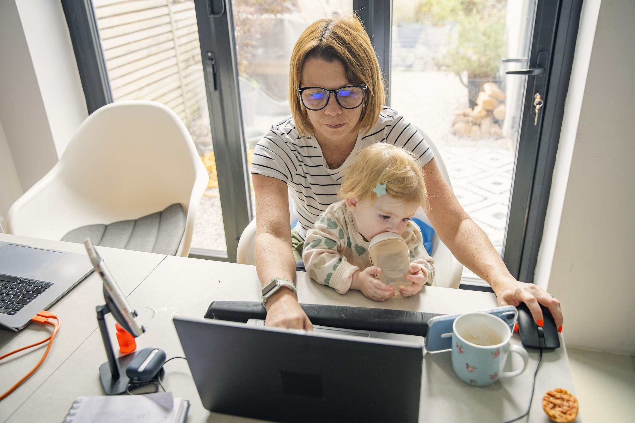 When Women Delay Their Own Care Busy Mom with Baby using her computer
