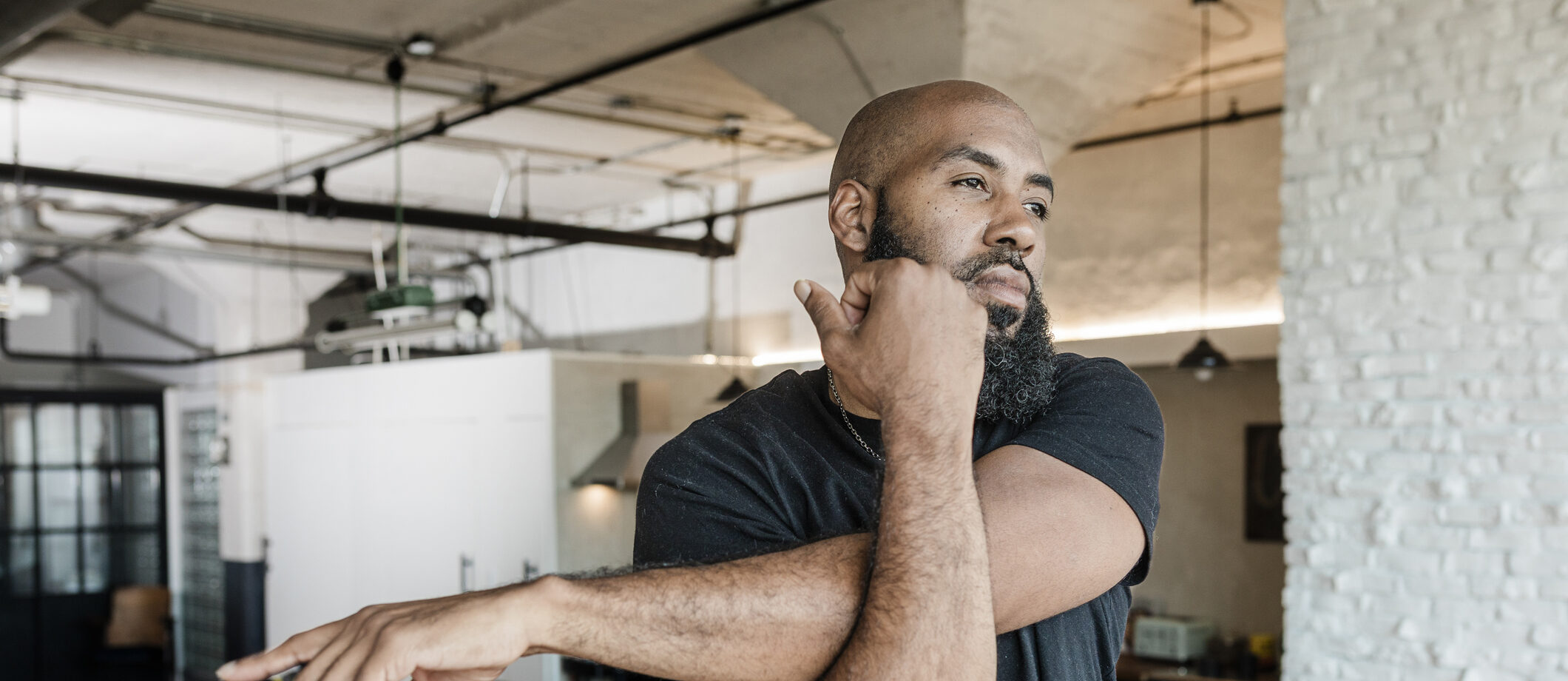 Precision, Innovation and Relief: Aquablation Therapy at Good Samaritan Hospital A man stretches his arm across his chest during a home workout or warm‑up.
