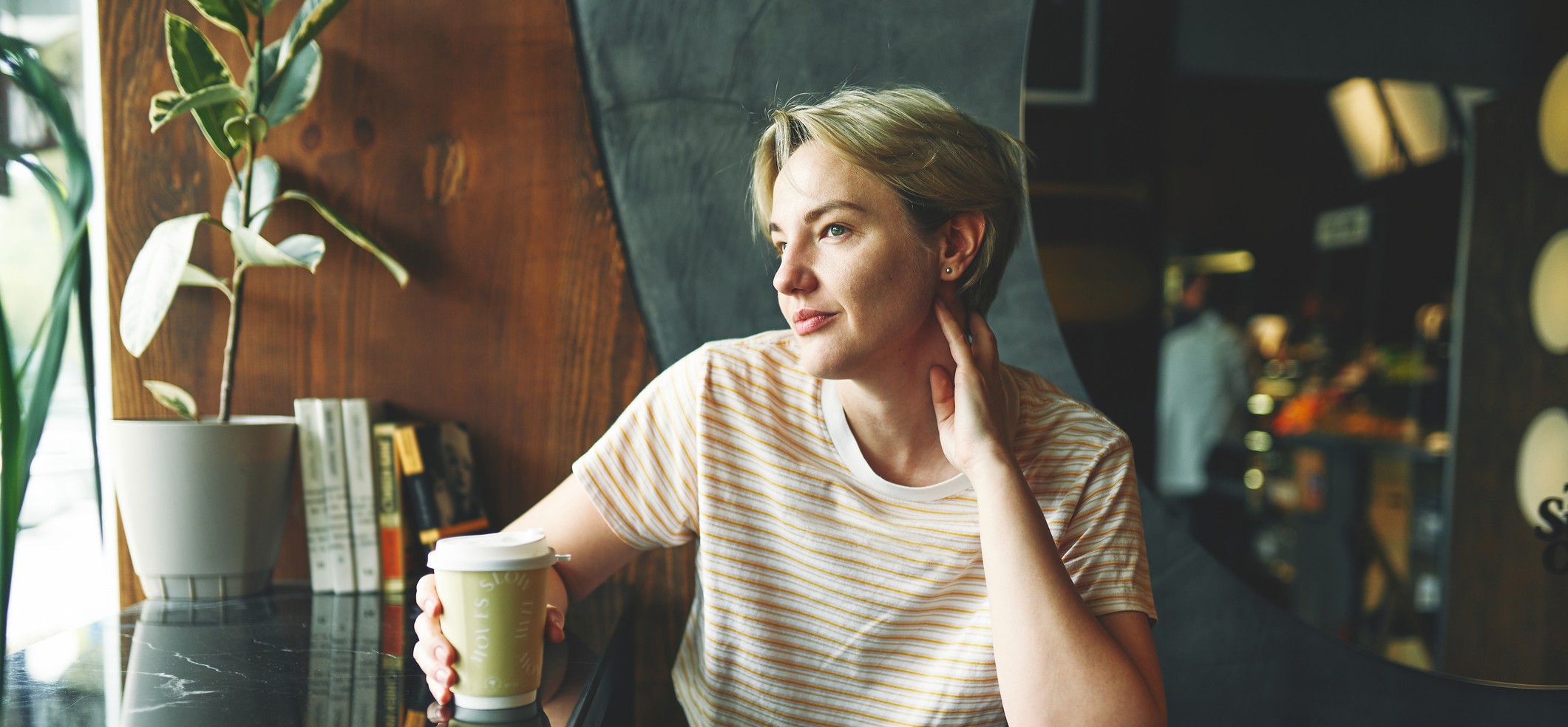 Businesswoman sitting at workstation in design firm , looking at window