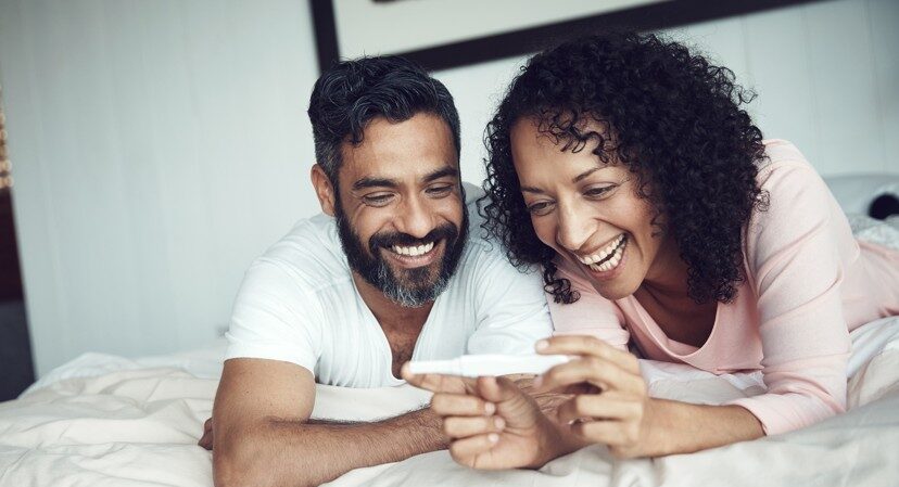 couple feeling happy after taking a home pregnancy test