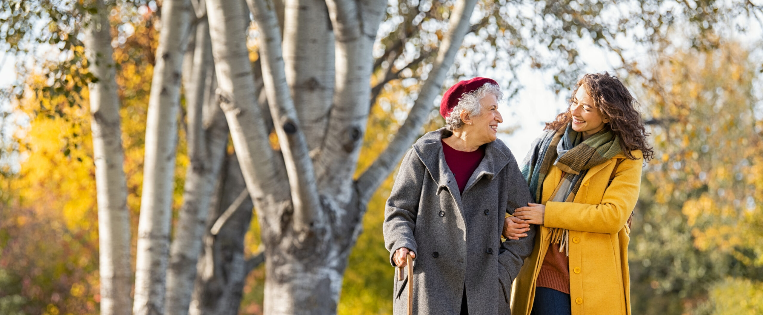Why Older Adults Fall and the Simple Steps That Can Prevent It Woman with grandmother walking in park in autumn