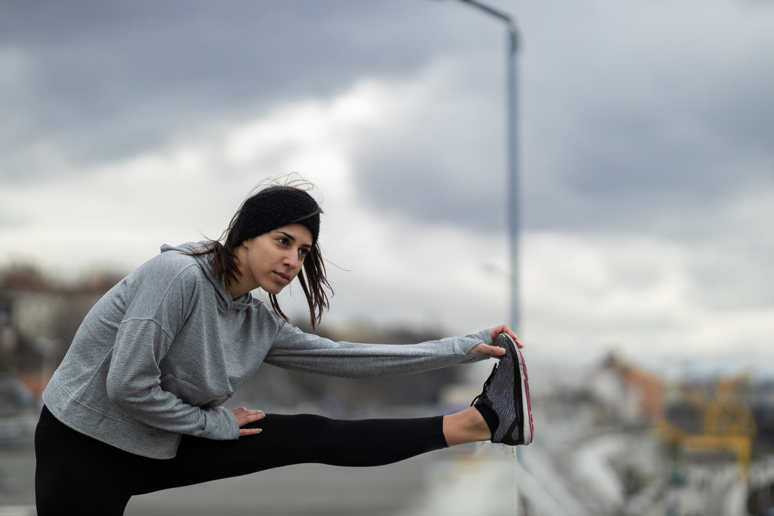 How to Stay Active When the Weather Turns Cold Attractive young Caucasian sportswoman exercising outdoors