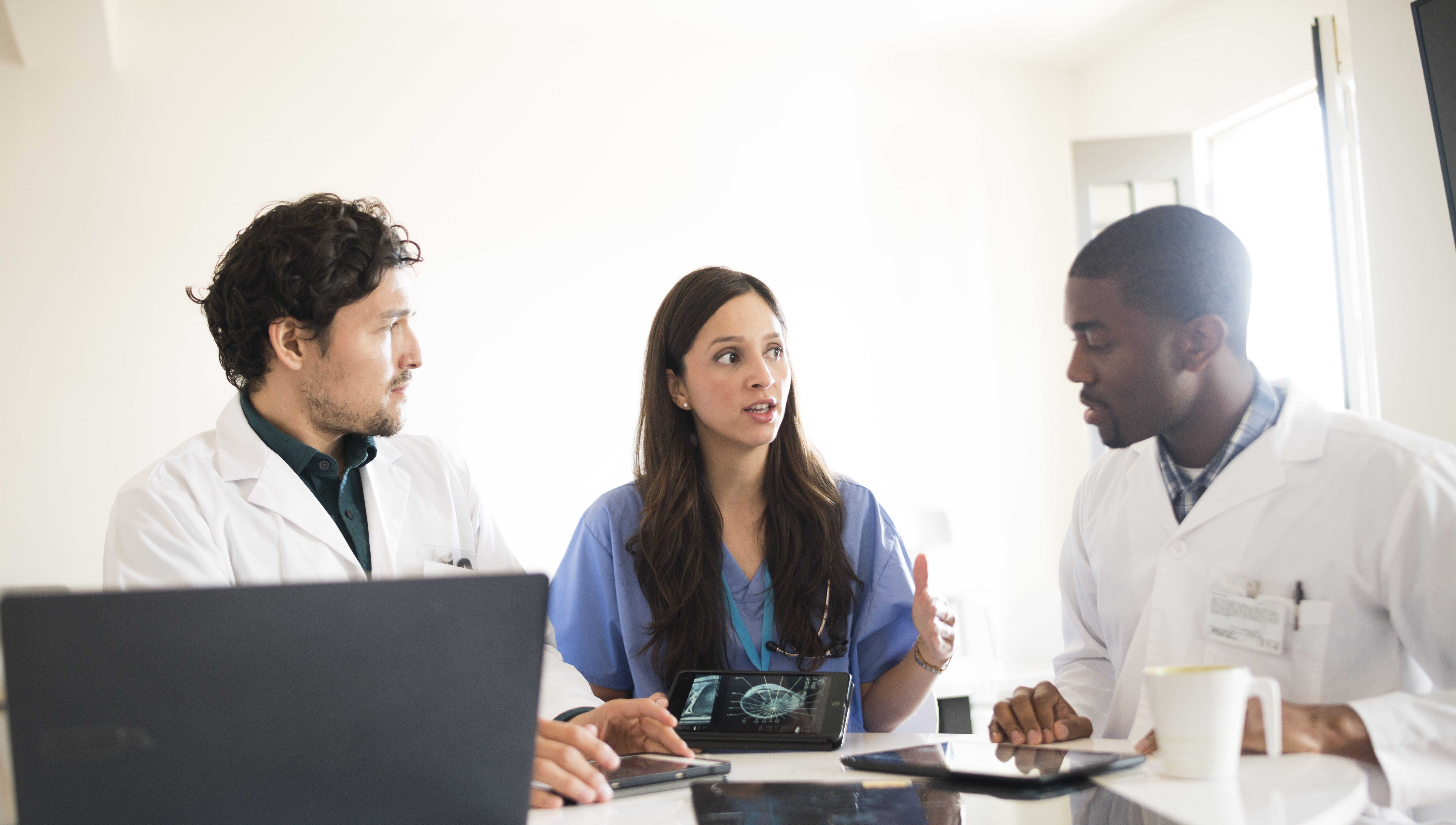 Doctors talking together with digital tablets and X-rays