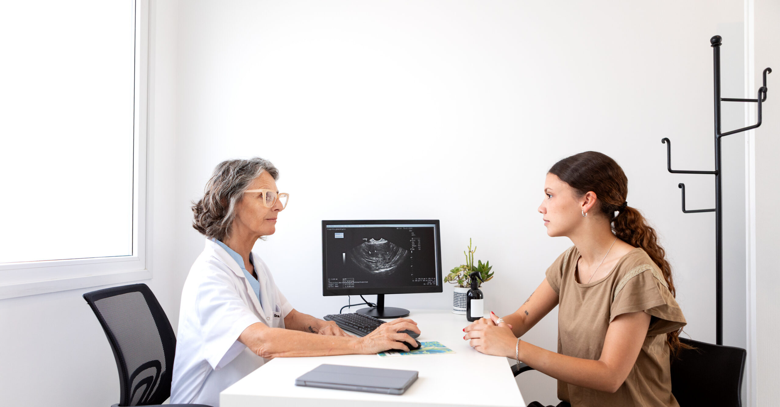 Female gynecologist in a consultation with her female patient analyzing medical exams